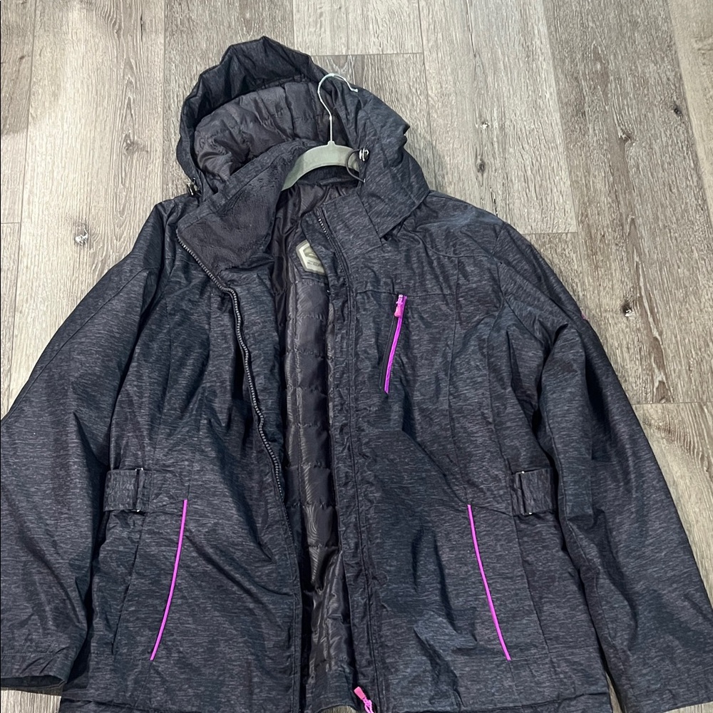 Woman’s charcoal, gray snow jacket with purple accents